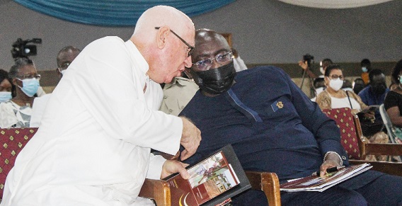 Vice-President Dr Mahamudu Bawumia (right) conferring with Rev. Fr Andrew Campbell during the launch of the SVD Foundation in Accra last Sunday.